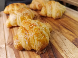 Close Up Of Golden Brown Baked Goods On Wooden Board