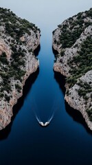 Aerial View of a Boat Navigating Through a Narrow Waterway Between Rocky Cliffs in the Mediterranean