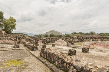 remains of the ruins of the ancient city of teotihuacan with the pyramid of son in the background