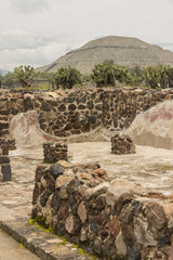 remains of the ruins of the ancient city of teotihuacan with the pyramid of son in the background