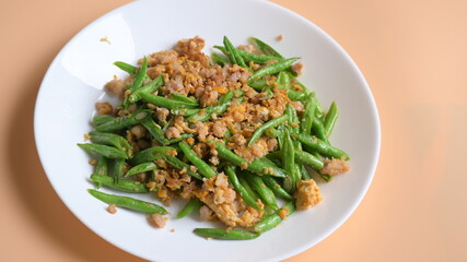 fried green bean with pork on white plate, thai and chinese food