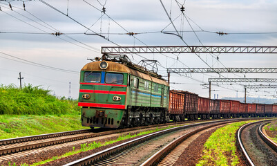Old electric locomotive hauling a freight train near Siversk, currently an active war zone in Russo-Ukrainian War in Donetsk region of Ukraine