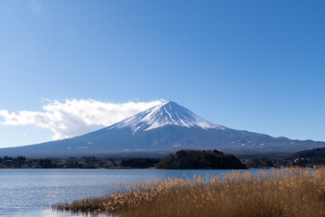 A breathtaking view of Mount Fuji, standing majestically above serene landscapes, with its iconic...