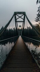 Fototapeta premium Wooden suspension bridge at dusk surrounded by forest with metal framework and walkway