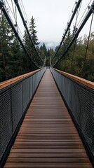 Wooden suspension bridge in a forest with metal railings and cables stretching into the distance.