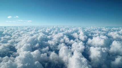 Fototapeta premium A serene view of fluffy white clouds stretching across a bright blue sky, creating a tranquil and expansive atmosphere.