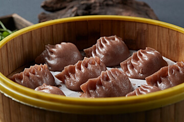 Freshly steamed buckwheat dumplings with vegetarian filling in a steamer