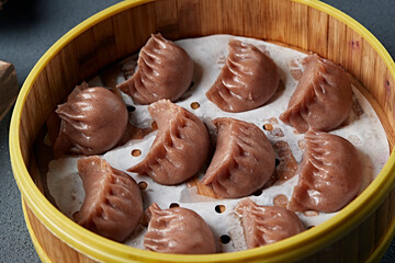 Freshly steamed buckwheat dumplings with vegetarian filling in a steamer