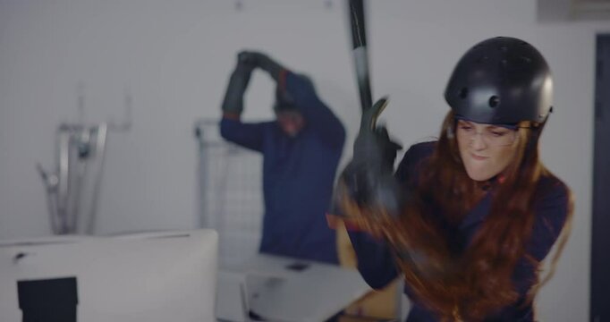 Destroy, rage room and woman with bat for breaking computer, vandalism and destruction. Weapon, wreckage and frustrated people with safety glasses for smashing pc, demolition and property damage