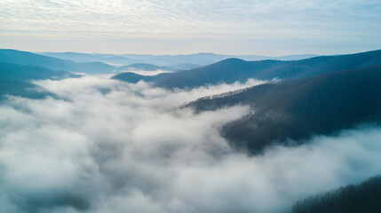 Obraz premium Misty Mountain Landscape Aerial View Scenic Nature Cloudscape Fog Sky Blue Hill Calm Vast Trees 