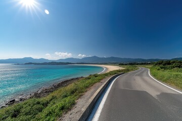 Sunny coastal road curves to a pristine beach
