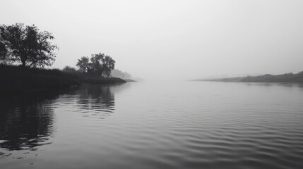 Fototapeta premium Misty Riverbanks With Silhouetted Trees Reflecting In Calm Water