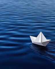 Obraz premium A serene paper boat gliding across calm blue water, representing tranquility and creativity in motion.