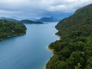 High-angle view of a serene Lake Waikaremoana surrounded by lush green forests. Tranquil waters reflect the overcast sky. Nature's beauty. , Lake Waikaremoana Track, Hawkes Bay, New Zealand