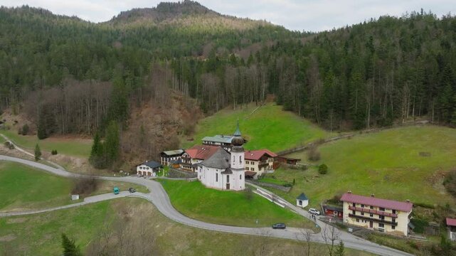 Maria Gern catholic church in Berchtesgaden of Bavarian Alps with famous Watzmann mountain range in the background, Bavaria, Drone shot