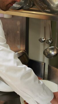 Handsome chef cleaning dishes