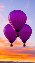 Obraz premium Three vibrant purple hot air balloons float against a stunning sunset backdrop, creating a magical travel experience.