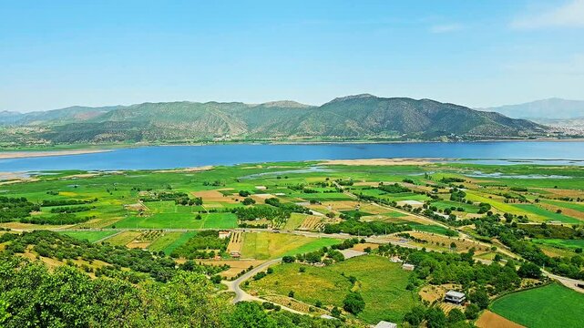 Stunning Lake Zarivar in Marivan, Iran, with lush fields, distant mountains, and a clear blue sky, showcasing nature's tranquil charm.
📍Marivan - Kurdistan 