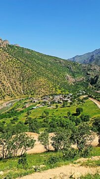 Picturesque Zom village beside the serene Sirvan River, surrounded by rugged mountains under a clear sky.
📍Zom village, Hawraman - Kurdistan 