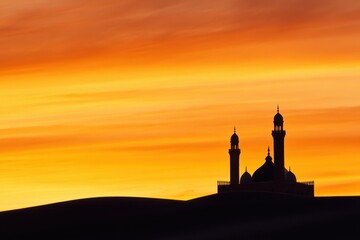 Silhouette of a mosque at sunset, vibrant orange and yellow sky, desert landscape
