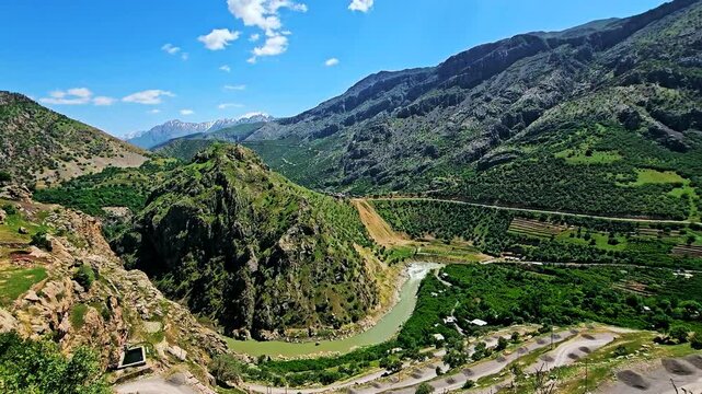 Stunning valley with a winding river, surrounded by rugged mountains under a vibrant blue sky.
📍Zhivar, Selin; Hawraman Takht - Kurdistan 