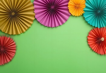 Paper fans and green background for copy space, colors of Juneteenth holiday.