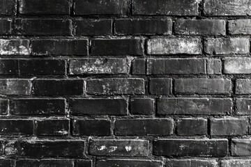 Close-up view of aged black brick wall