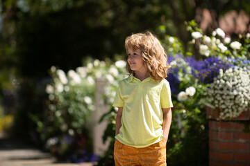 Little child play on summer backyard. Outdoor closeup portrait of funny kids face. Summer kid...