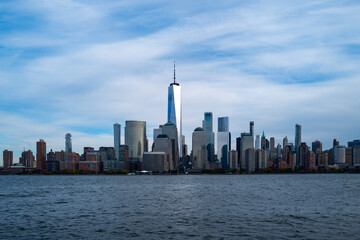 New York City cloudy skyline. NYC skyscrapers. Manhattan. NY cityscape with clouds. Downtown New York buildings. NYC skyline. New York harbor view. Skyscrapers in Manhattan. NYC downtown.