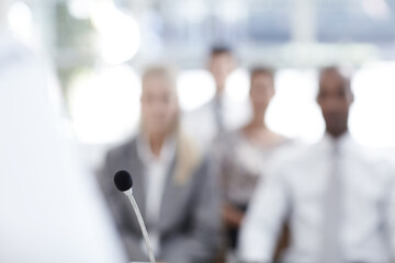 Person, business people and microphone for speech, public speaking or announcement in conference. Professional, host and presenter on podium in seminar for press information, news update or event