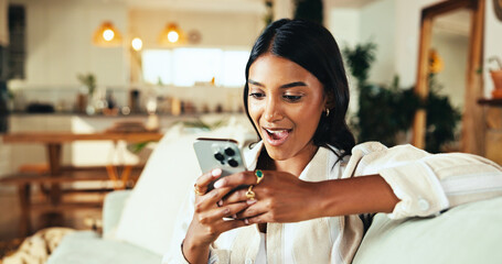 Woman, phone and surprise on sofa in home, gossip and online dating with texting in living room. Girl, person and wow with mobile app, shock and notification on social network in lounge at apartment