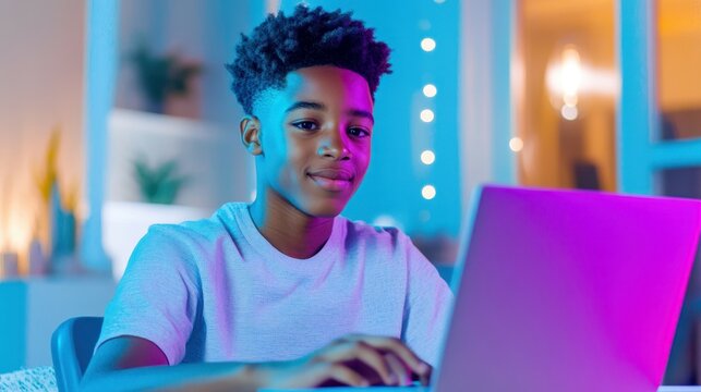 Teenager Working on Laptop: A smiling teenage boy diligently works on his laptop, illuminated by vibrant purple and blue neon lighting, creating a dynamic and modern atmosphere. - Powered by Adobe