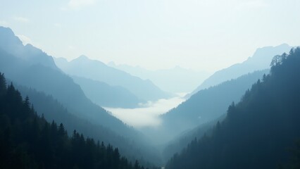 Fototapeta premium A majestic mountainous valley with fog drifting between the hills, creating a serene and tranquil landscape.