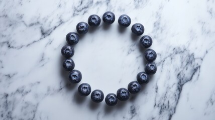 Fresh blueberries arranged in circular pattern on marble background