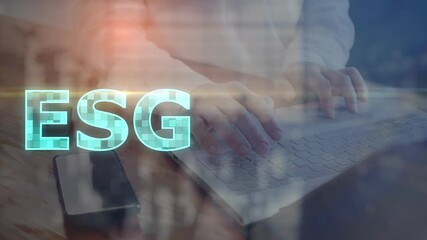 Concept. The abbreviation Environmental, Social and Corporate Governance against a translucent silhouette of a person working on a computer. Cg