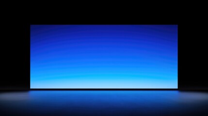 Fototapeta premium Wide blue gradient screen in dark room, reflecting on floor.