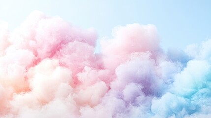 Fototapeta premium Fluffy pastel clouds in shades of pink, blue, and yellow float across a bright sky, creating a dreamy and whimsical background.