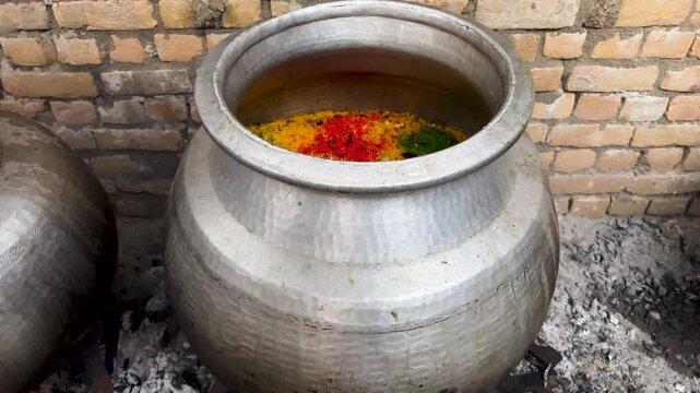 Degi Zarda Chawal or Pakistani Sweet Rice in Traditional Cooking Pot at Festival or Cultural Events
