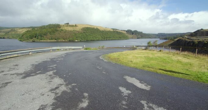 Extra wide shot of access Road at the Llyn Brianne dam with the Reservoir in background. Rhandirmwyn, Llandovery