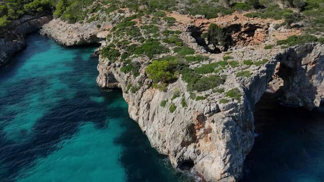 Experience the breathtaking beauty of Cala Varques, featuring crystal-clear waters and rugged cliffs in Majorca. A perfect destination for nature lovers and adventure seekers alike.