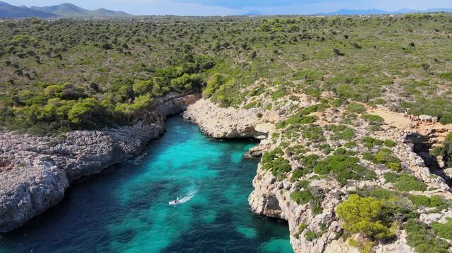 Experience the natural beauty of Cala Varques in Majorca with its rocky cliffs and clear turquoise waters. This serene coastal landscape showcases the charm of Porto Cristo and Calas de Mallorca.