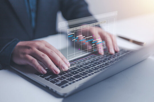 Businessman marking the schedule. Businessman using laptop create a calendar program, rganize and schedule activity and event planner, a calendar page shows on laptop, scheduler, date appointing