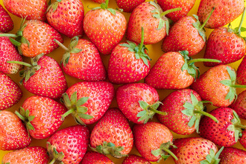 Strawberries Arranged on a Yellow Background