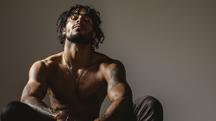 A confident individual exudes authenticity and self-acceptance in a focused portrait, featuring an inviting expression against a neutral background.