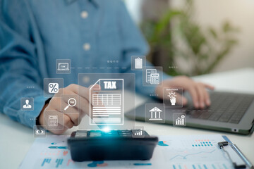 Businessmen use a computer for Tax planning and calculation and complete Individual income tax return form online tax payment to Government. Data analysis, paperwork, financial research, and reports.
