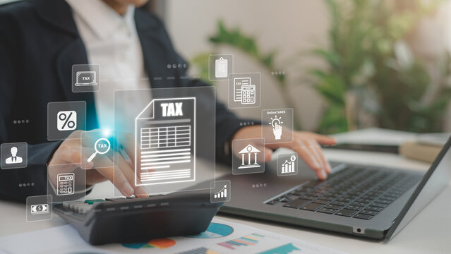 Businessmen use a computer for Tax planning and calculation and complete Individual income tax return form online tax payment to Government. Data analysis, paperwork, financial research, and reports.
