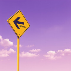 A vibrant yellow transportation arrow sign with the word 'HOSTEL' against a stunning violet sky background, perfect for travel, adventure, and road trip themes.