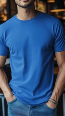 A man wearing blue color t shirt mockup; with bracelet; at the cafe; front view