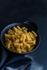 Raw fusilli pasta in the bowl