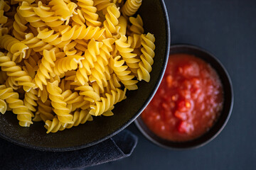Raw fusilli pasta in the bowl
